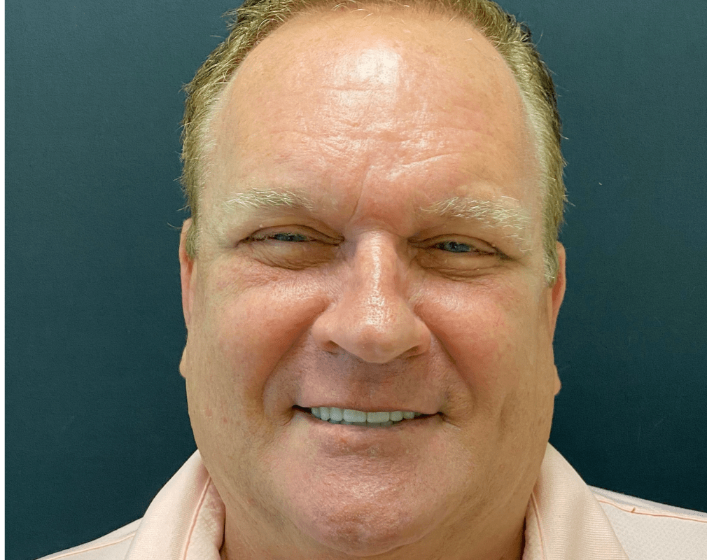 Smiling man with light-colored shirt